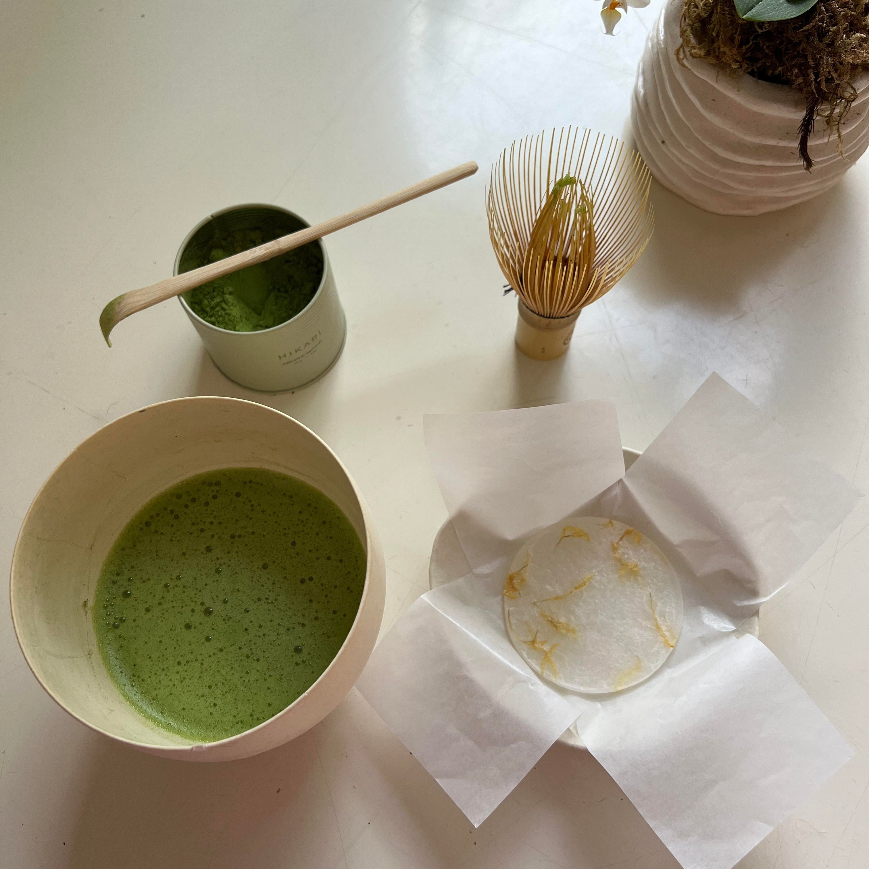 HIKARI Matcha tea in a bowl with chosen whisk and wagashi treat. 